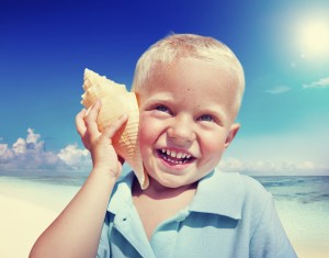 Little Boy Beach Seashell Fun Vacation Concept